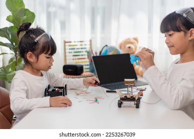 Asia students learn at home in coding robot cars and electronic board cables in STEM, STEAM, mathematics engineering science technology computer code in robotics for kids concept.