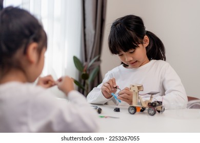 Asia students learn at home in coding robot cars and electronic board cables in STEM, STEAM, mathematics engineering science technology computer code in robotics for kids concept.