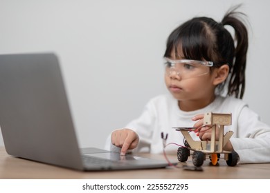 Asia students learn at home in coding robot cars and electronic board cables in STEM, STEAM, mathematics engineering science technology computer code in robotics for kids concept.