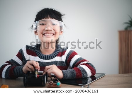 Asia students learn at home in coding robot cars and electronic board cables in STEM, STEAM, mathematics engineering science technology computer code in robotics for kids concept.