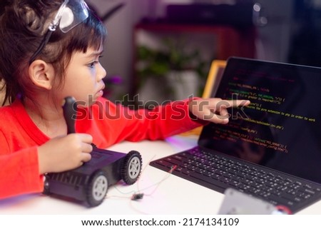 Asia students learn at home in coding robot cars and electronic board cables in STEM, STEAM, mathematics engineering science technology computer code in robotics for kids concept.