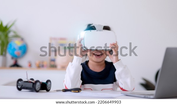 Asia students\
learn at home in coding robot cars and electronic board cables in\
STEM, STEAM, mathematics engineering science technology computer\
code in robotics for kids\
concept.
