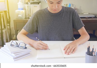 Asia Teen Writing On A Book.