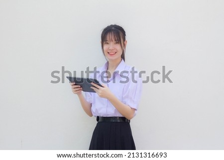 asia thai high school student uniform beautiful girl using her tablet
