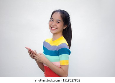 Asia Thai Teen Color T-shirt Beautiful Girl Using Her Phone And Smile