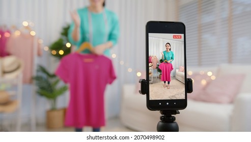 Asia vlogger woman influencer, SME retail store owner smile enjoy selling show live sale online screen in IG story reel tiktok work at home studio. Gen Z people record viral video selfie shoot app.