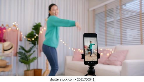 Asia vlogger woman influencer smile enjoy hobby happy fun live online screen SME retail store in IG reel tiktok at home. Gen Z talent people play video selfie shoot app for show share viral story.