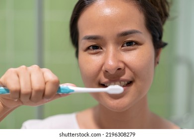 Asia Woman Brushing Her Teeth.