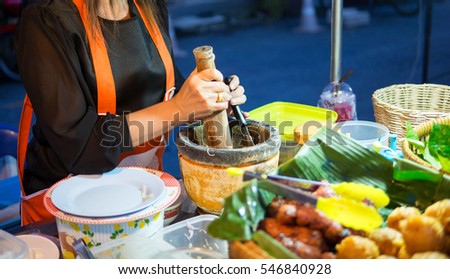 asia woman cook papaya salad and sour pork at street night market