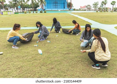 Asia Woman Group Team Volunteer Picking Up Trash Plastics Garbage Plastic Waste. Friend Putting Plastic Garbage Waste Into Bag At Park Concept Team Volunteer Charity Reduce Global Warming Save Earth