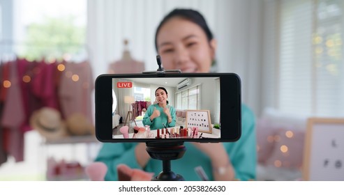 Asia woman micro influencer record live viral video camera at home studio. Happy youtuber fun talk speak advice review hobby in media. Vlogger selfie shoot enjoy work show smile teach like share app. - Shutterstock ID 2053826630
