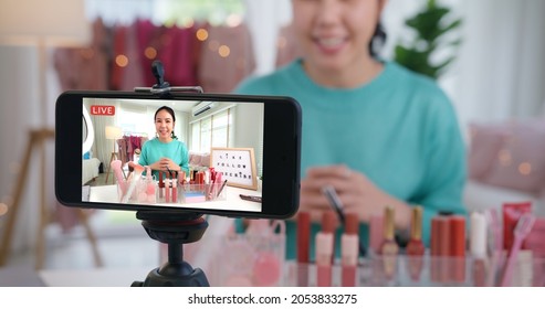 Asia woman micro influencer record live viral video camera at home studio. Happy youtuber fun talk speak advice review hobby in media. Vlogger selfie shoot enjoy work show smile teach like share app. - Shutterstock ID 2053833275