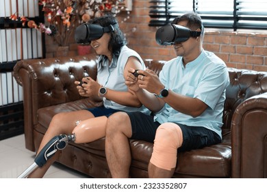 Asia woman with prosthetic leg and boyfriend play game of VR at home	 - Powered by Shutterstock