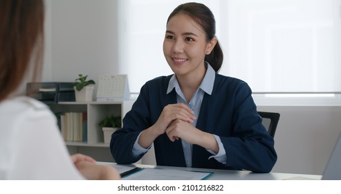 Asia Woman Real Estate Sale Agent Or Trader Advice Sitting At Lawyer Office Desk  Smile Trust Talk In Wealth Service Legal Tax Consult. HR People Brief Or Coach For Happy Work Plan In Bank Loan Job. 