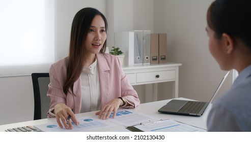 Asia Woman Real Estate Sale Agent Or Trader Advice Sitting At Lawyer Office Desk  Smile Trust Talk In Wealth Service Legal Tax Consult. HR People Brief Or Coach For Happy Work Plan In Bank Loan Job. 