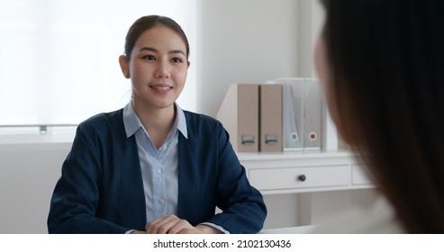 Asia Woman Real Estate Sale Agent Or Trader Advice Sitting At Lawyer Office Desk  Smile Trust Talk In Wealth Service Legal Tax Consult. HR People Brief Or Coach For Happy Work Plan In Bank Loan Job. 