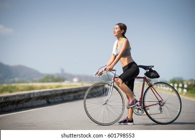 Asia Woman Ride A Bicycle Race Style Sport, Copy Space On Left Side.