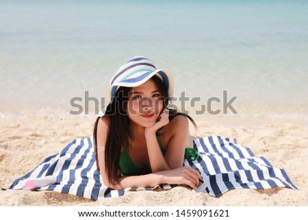 Asia woman sunbathing on beach, Summer beach vacation concept