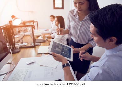 Asia Woman Use Tablet For Consulting With Her Boss About The Needs Of The Client In The Design.