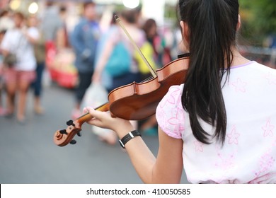  Asia Women Play Brown Wood Violin On Street, Chinese Play Music With Violin Outdoor, Musician Instrument. Back View