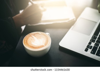 Asia Women Working In A Caffee Shop, Focus To Latte Art.