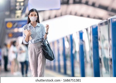 Asia Working Woman Going To Work And  
Wearing Hygienic Mask Prevent Corona Virus And Going To Work At
Sky Train Station