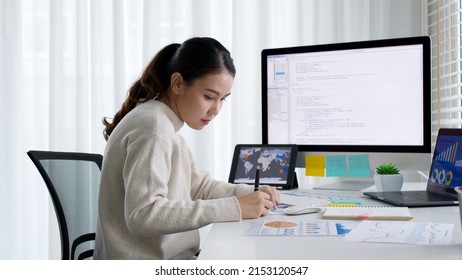 Asia Young Business Woman Sit Busy At Home Office Desk Work Code On Desktop Reskill Upskill For Job Career Remote Self Test IT Deep Tech Ai Design Skill Online Html Text For Cyber Security Workforce.