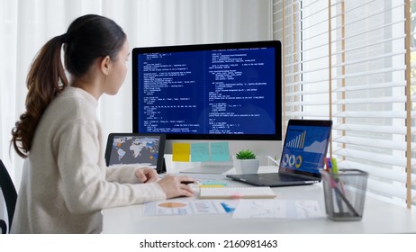 Asia Young Business Woman Sit Busy At Home Office Desk Work Code On Desktop Reskill Upskill For Job Career Remote Self Test IT Deep Tech Ai Design Skill Online Html Text For Cyber Security Workforce.