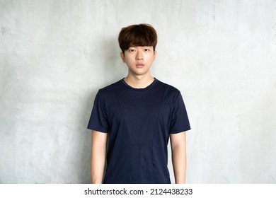 Asia Young Man On Gray Background And Looking At Camera. Casual Young Man.