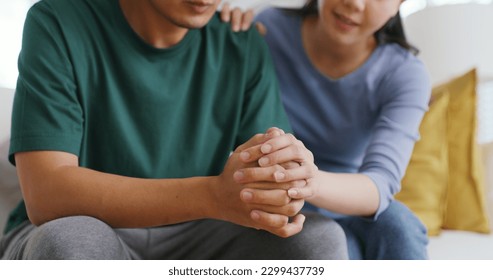 Asia young people stress relief trust talk share suffer cancer pain sick family loss bad news crisis. Sorrow cry man and carer woman sit at sofa home help listen by love hold hand warm hug touch wife.