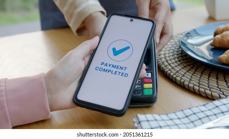 Asia young smile happy woman people in small sme coffee shop store use tapping cashless wifi qr code nfc scan app smart pos device reader sale in food drink order in cafe urban city life contactless. - Powered by Shutterstock