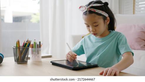 Asia Young Student Alpha Gen Z Girl Fun Play Look At Touch Screen Use Stylus Pen Design Idea Coloring Art On Home School Online Class App. Smart Kid Happy Leisure Indoor Activity Sit At Table Sofa.