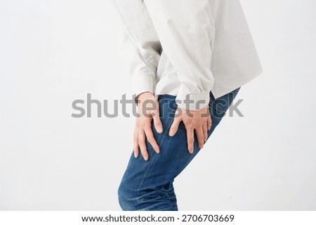 Asian 20s man with sciatica in white background