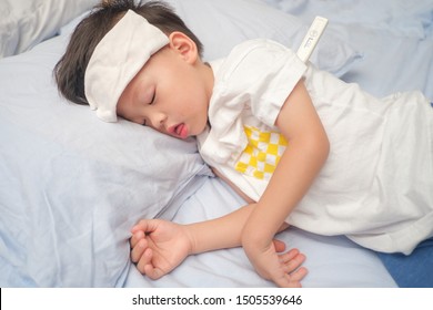 Asian 3 - 4 Years Old Toddler Boy Gets High Fever Lying On Bed With Cold Compress, Wet Washcloth On Forehead To Relieve Pain, Cool A Fever. Holding / Measuring Temperature With Medical Thermometer