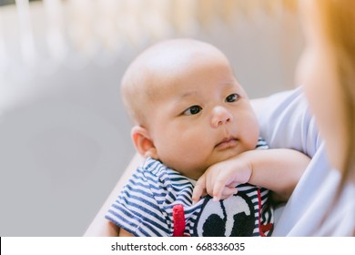 Asian 3 Month Baby Looking Up At Mother.Mother And Baby.Love Tender And Care Concept.