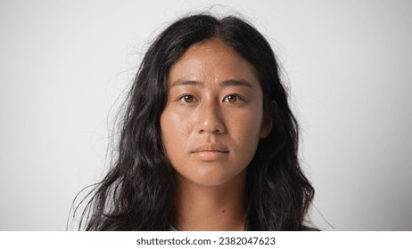 Asian 30s woman look camera close up. 20 years old chinese girl head shot. One japanese face portrait. Asia korean life. Cute sad young adult thai lady. Korea skin care cream. China no makeup style. - Powered by Shutterstock