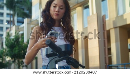 Similar – Image, Stock Photo Girl using electric scooter in the street in downtown rented by using service on smartphone. Candid people, real moments, authentic situations