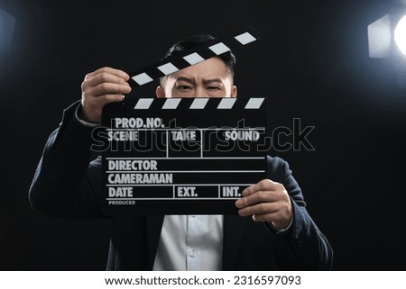 Asian actor with clapperboard on stage. Film industry