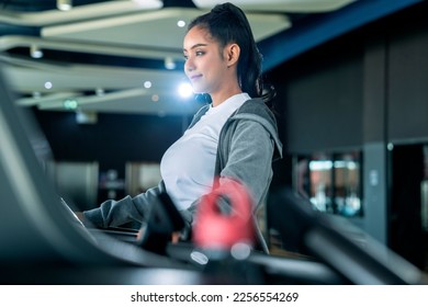 asian adult female sport woman jogger running on treadmill athletic working out active healthy lifestyle with cheerful freshness sweaty cardio exercise at fitness gym sport club morning wellness day - Shutterstock ID 2256554269