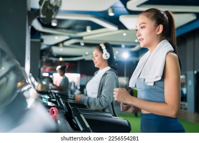 asian adult female sport woman jogger running on treadmill athletic working out active healthy lifestyle with cheerful freshness sweaty cardio exercise at fitness gym sport club morning wellness day - Shutterstock ID 2256554281