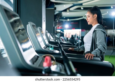 asian adult female sport woman jogger running on treadmill athletic working out active healthy lifestyle with cheerful freshness sweaty cardio exercise at fitness gym sport club morning wellness day - Shutterstock ID 2256554295
