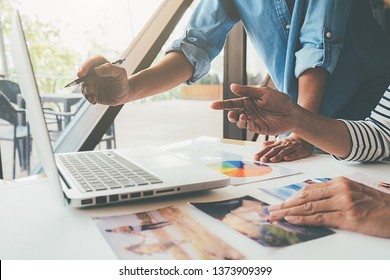 Asian advertising designer creative start-up team discussing ideas in office. - Shutterstock ID 1373909399