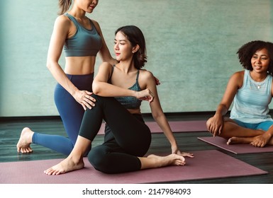 Asian  And African American Woman Friend Doing Yoga Pilates Workout Together At Gym.Group Of Diversity Practicing Yoga Class, Healthy Exercise,stretching In  Exercise, Wearing Sportswear Bra .