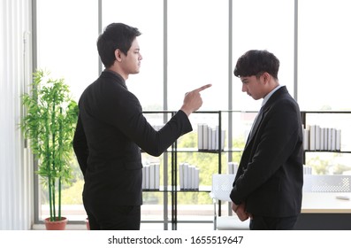 Asian Aggressive Angry Boss Manager Complaining  Employee. He Very Angry Then Point To Face Office And  Bind Over In Room Office. Bangkok Thailand South East Asia