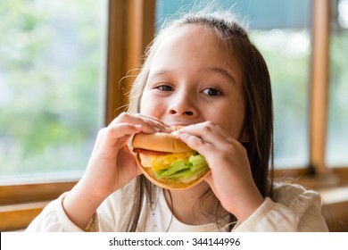 Asian American Girl Eating Burger