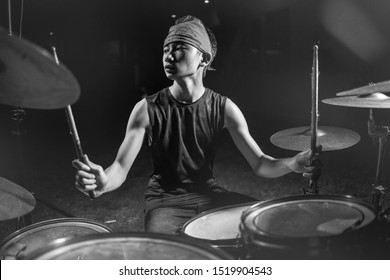 Asian American Mixed Teenager Playing Drums At Home Garden . Cool And Handsome Young Boy Practicing On Drum Kit Rehearsing Passionate In Badass Rock Band Look Enjoying The Practice