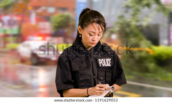 Asian American Woman Police Officer at Crime scene
Taking Notes
