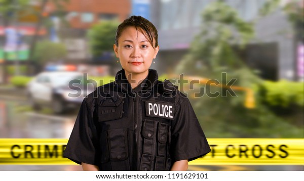 Asian\
American Woman Police Officer Smiles at\
Camera