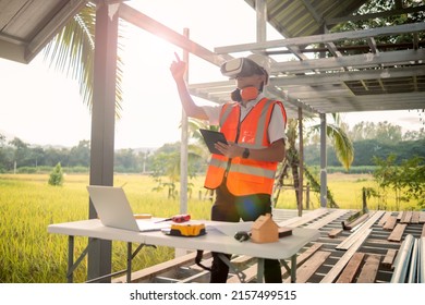 Asian architect engineer using VR tablet simulation planning designing blueprint, futuristic program software for architectural innovation, construction site building project using modern technology.