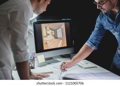 Asian Architect Or Interior Designer Team Staying Late At Night In Office Discussing Room Design Project At Meeting Table